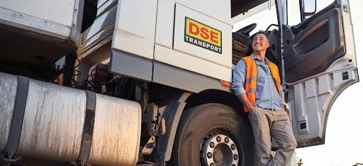 A DSE Transport worker in an orange safety vest