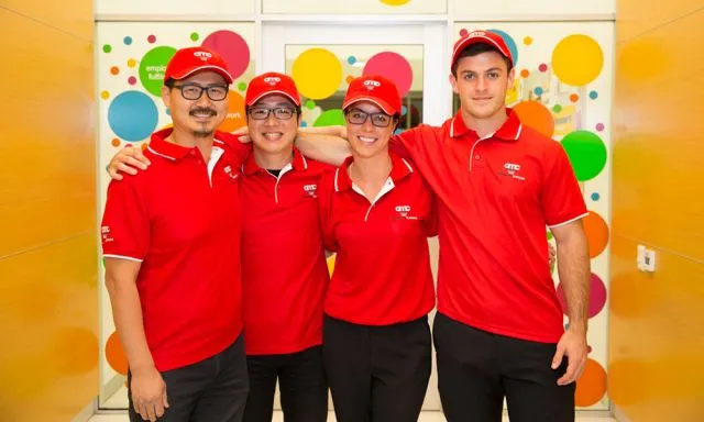 a group of a happy workers in red uniforms