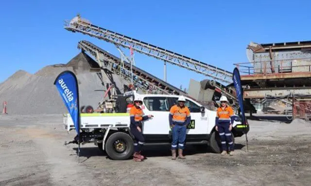 a group of workers in high vis and hard hats on a mining site