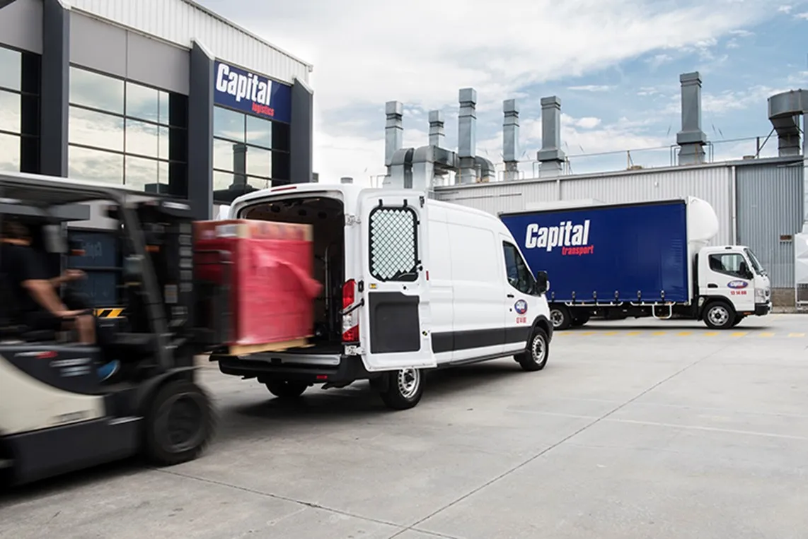 Forklift unloading goods from a van