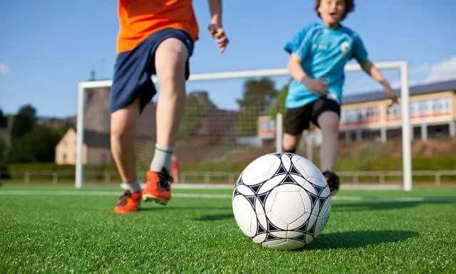 two people playing soccer