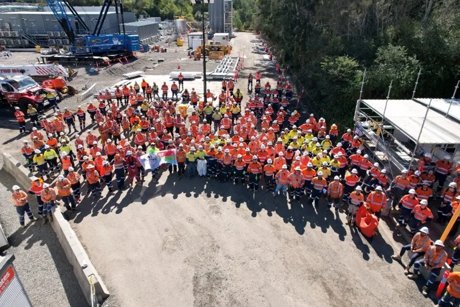 Overhead view of workers on a construction site in hard hats and high-visibility clothing