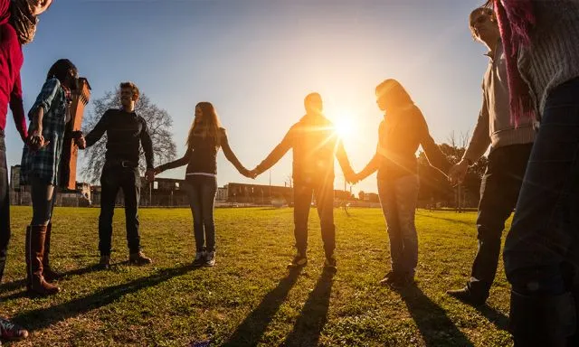 a group of people holding hands