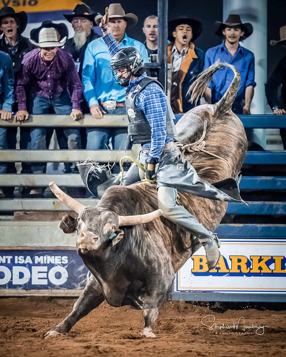 a man wearing a helmet riding a bull