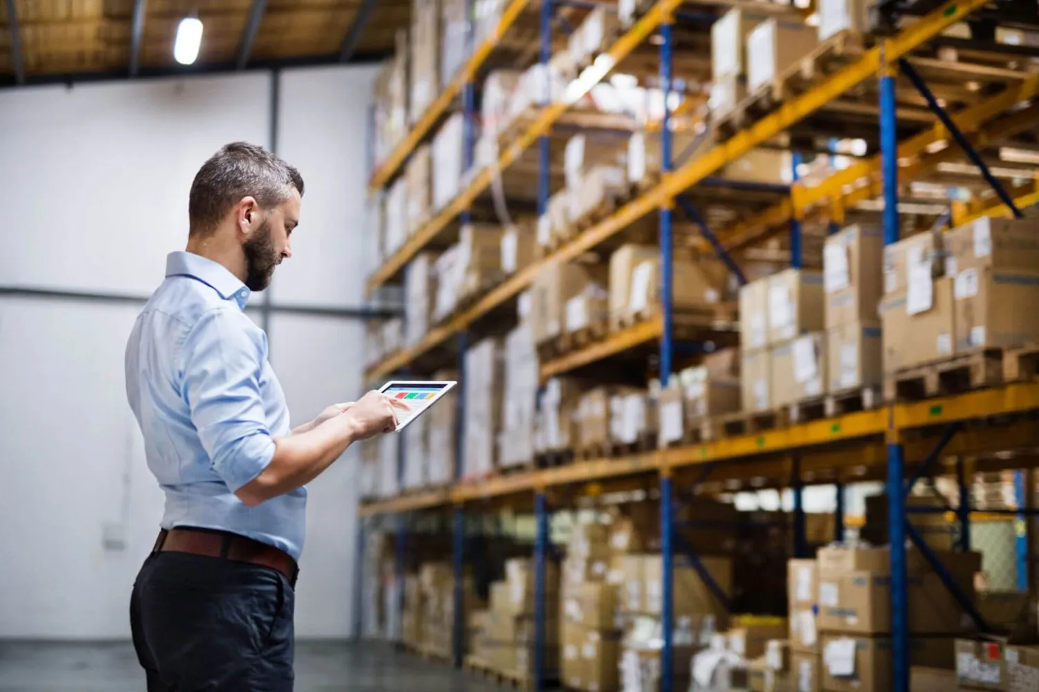 Man warehouse worker with a tablet.