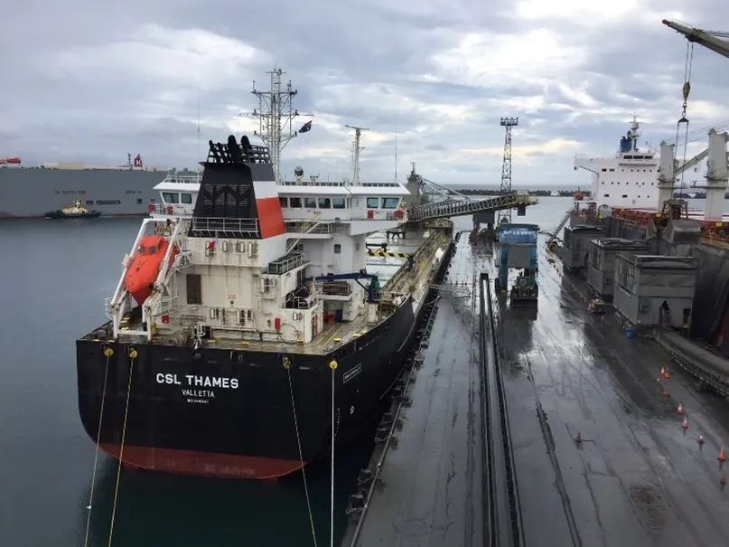 A cargo ship docked at PKG Number 6 Jetty, waiting to unload cargo. The image represents how PKG, a busy port terminal, transformed its induction process.