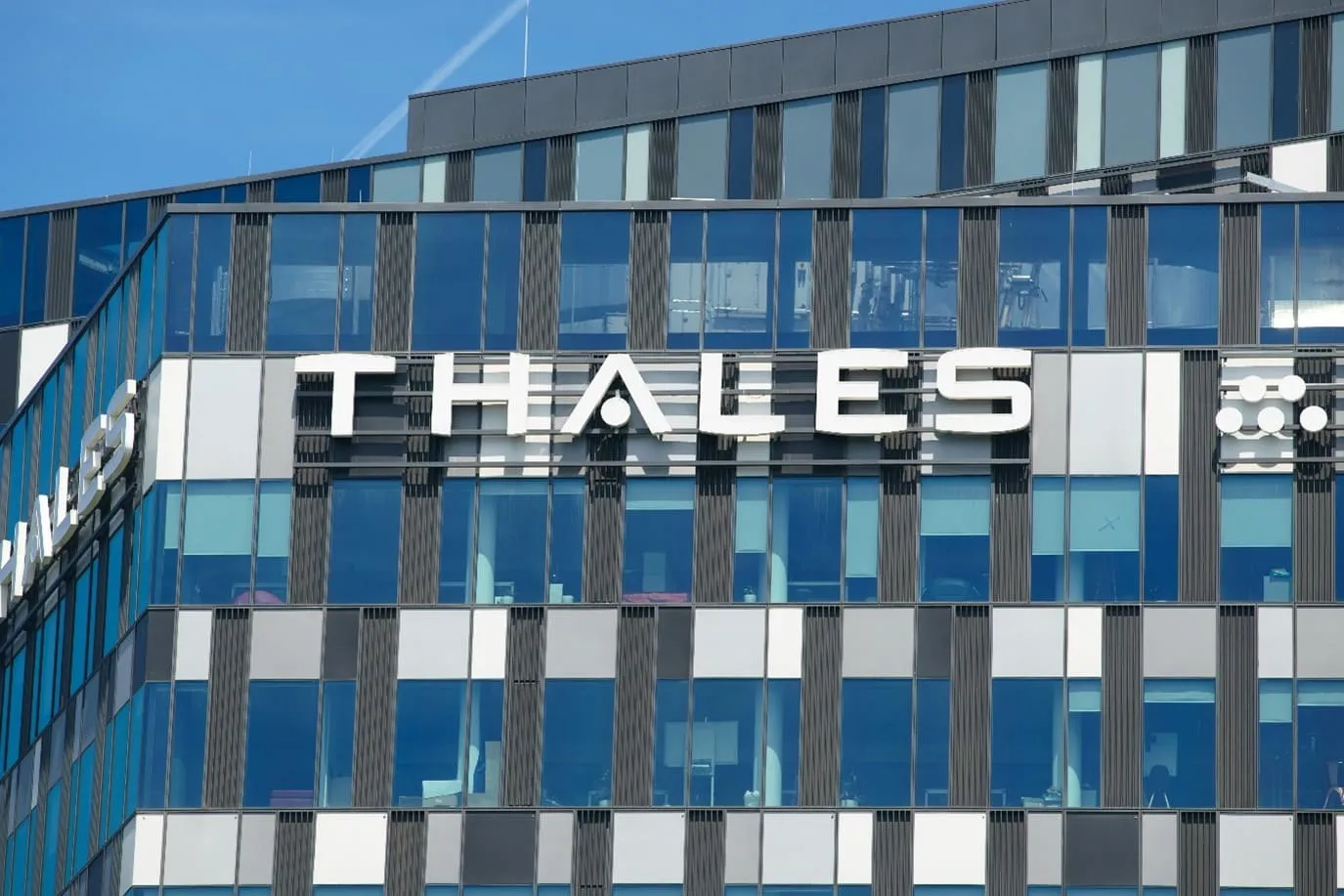 Close-up of office building with Thales logo. Image represents how Thales Group managed contractor onboarding.