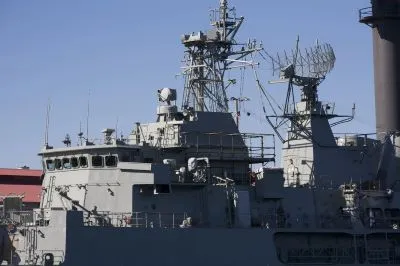 Grey warship with blue sky in background. Image represents how Thales Group managed contractor onboarding.